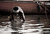Coin Fishing Photo: A man manually dredges the shallows of the Ganges River in hopes of finding deposited coins.