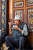 Foodie Photo: A Chinese man delicately places a morsel of food into his mouth.  Is it just me or does anyone else like the character on the man's face?  He's got the benign appearance of a friendly uncle that makes me want to be friends with him.