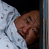 Rude Awakening Photo: My Gobi dessert tour driver's sleeping accommodation is the emptied back of our versatile Jaman Yos, a Soviet era tank of a van.  I suppose his startled reaction is normal for anyone awoken by a 70-200mm lens pointing at his face.  Luckily he's one of the kindest Mongolians I've met and he didn't want to tear my heart out for the rude awakening.