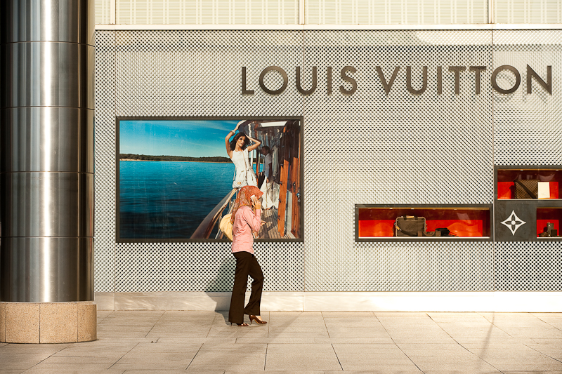 An ethnic Malay woman walks in front of a Louis Vuitton store. - Kuala Lumpur, Malaysia - Daily Travel Photos