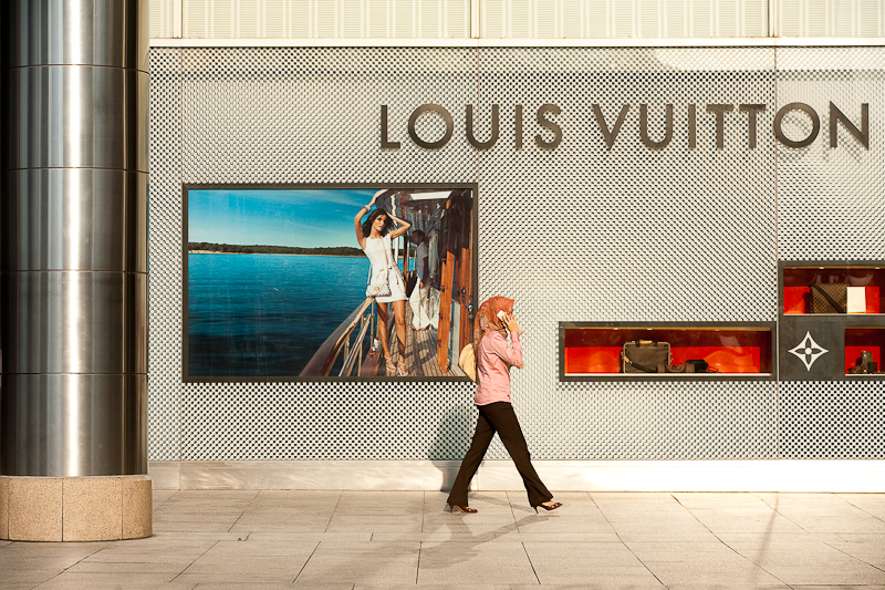 An ethnic Malay woman walks in front of a Louis Vuitton store. - Kuala Lumpur, Malaysia - Daily Travel Photos
