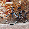 photo: Fittingly Flanders - Bicycles parked outside a traditional brick building.