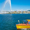 'Spensive City Photo: A yellow passenger taxi plies the pristine waters of Lake Geneva as jet d'Eau water fountain shoots into the sky.