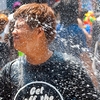 Songkran Hose Hounds Photo: A young Thai guy gets a hose-full of cleansing water during Songkran water festival.