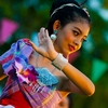 Songkran Tiny Dancer Photo: A cute Thai girl performs a native dance in colorful garb for Songkran, Thai new year.