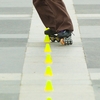 Intricate Inliners Photo: An inline skater slaloms a course of small, evenly-spaced pylons at Central World Mall in Bangkok.