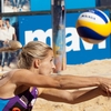 photo: Double Threat - A women's beach volleyball player returns a high-speed spiked ball.